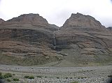 Tibet Kailash 08 Kora 16 Waterfall In Longevity Buddhas On the left (west) are three peaks known as the three longevity Buddhas: Dlma (Tara), Amitayus (Tib. Tsepagme) and Namgyalma (Tib. Vijaya). A long trailing waterfall spills between them, said to be Gesars saddle. Gesar is the hero-king of Tibets great epic story.